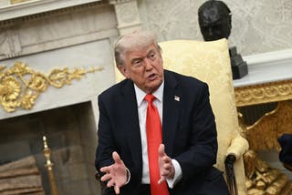 US President Donald Trump talks to German Chancellor Friedrich Border at the White House Oval Office
